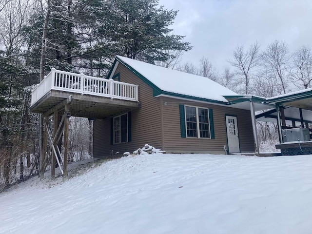 view of snowy exterior featuring a deck