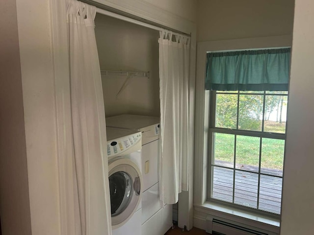 laundry area with washer and clothes dryer and a baseboard heating unit