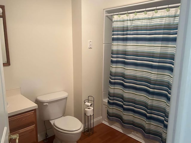 full bathroom featuring toilet, vanity, shower / tub combo, and hardwood / wood-style flooring