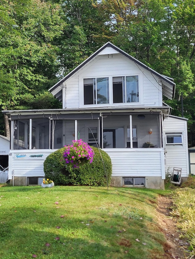 exterior space featuring a sunroom and a yard