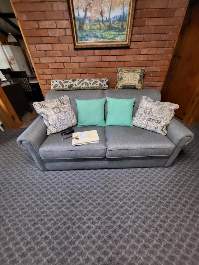 unfurnished living room featuring carpet flooring and brick wall