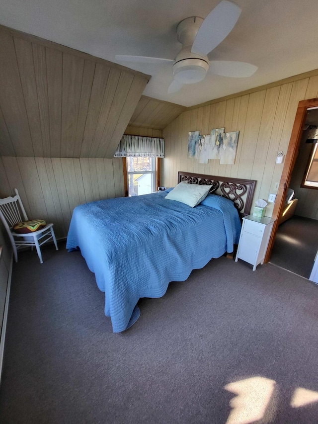 carpeted bedroom featuring wooden walls, ceiling fan, and lofted ceiling