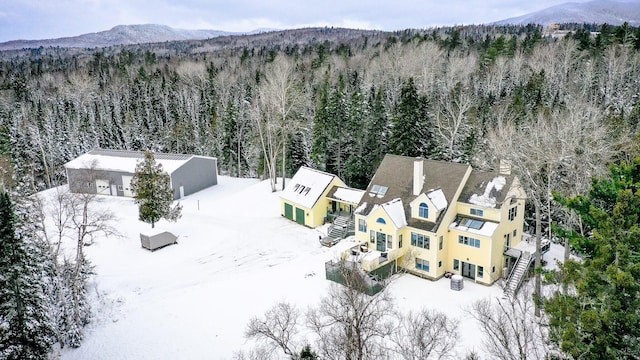 snowy aerial view featuring a mountain view