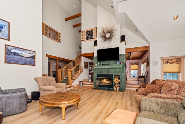 living room featuring wood-type flooring, high vaulted ceiling, and beam ceiling