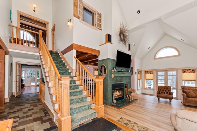 living room with french doors, high vaulted ceiling, and plenty of natural light