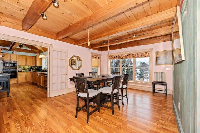 dining room with french doors, rail lighting, beamed ceiling, light hardwood / wood-style floors, and wood ceiling