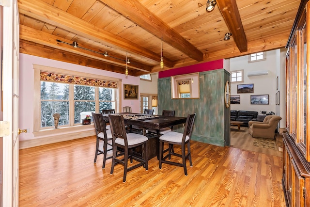 dining room with beam ceiling, light wood-type flooring, wood ceiling, and a wall mounted AC