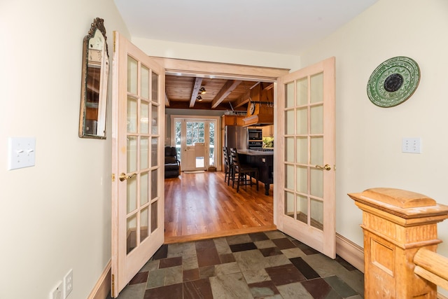 hallway featuring beamed ceiling, wood ceiling, dark wood-type flooring, and french doors