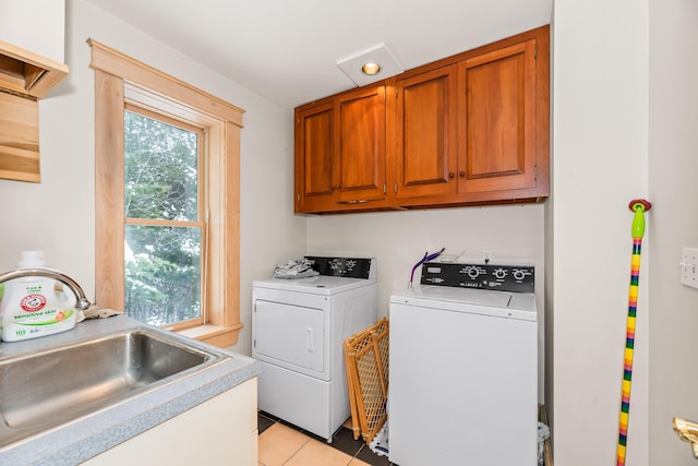 laundry room featuring cabinets, light tile patterned floors, separate washer and dryer, and sink