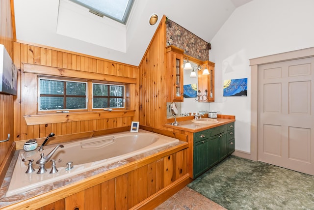 bathroom featuring vanity, lofted ceiling with skylight, a bathtub, and wooden walls