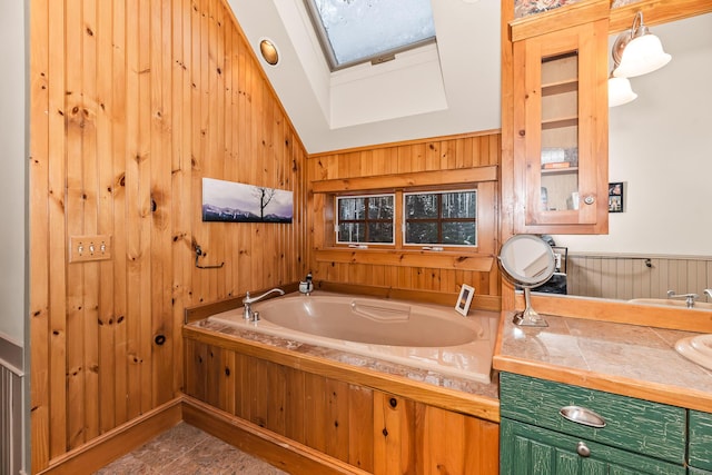 bathroom featuring wooden walls, vaulted ceiling with skylight, and a bath