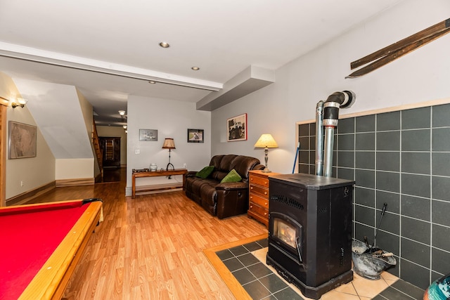 recreation room with wood-type flooring, a wood stove, and billiards