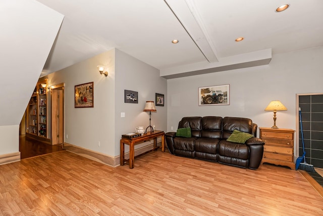 living room featuring light hardwood / wood-style flooring and beamed ceiling