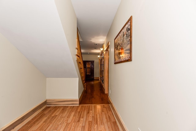 corridor with hardwood / wood-style flooring