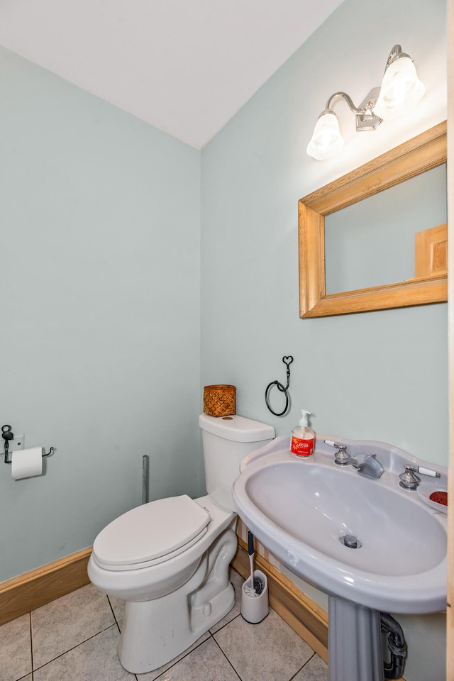 bathroom featuring tile patterned flooring, toilet, and sink