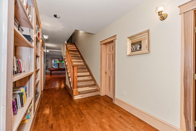 hallway with dark hardwood / wood-style flooring