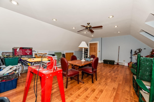 dining area with hardwood / wood-style floors, baseboard heating, ceiling fan, and lofted ceiling