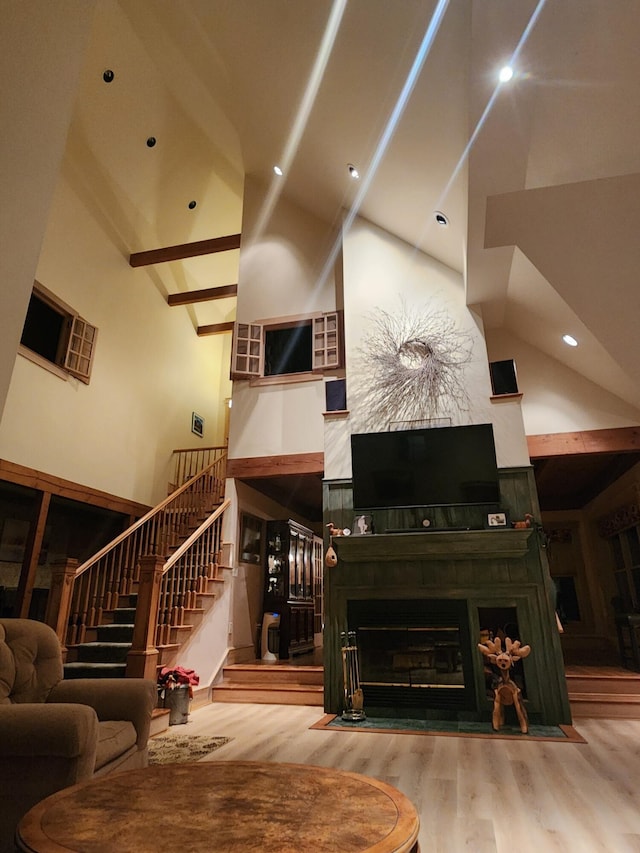 living room featuring high vaulted ceiling and wood-type flooring