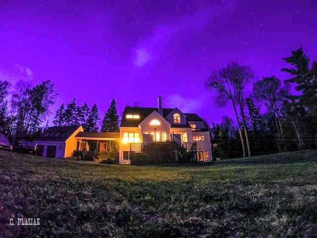 new england style home featuring a lawn