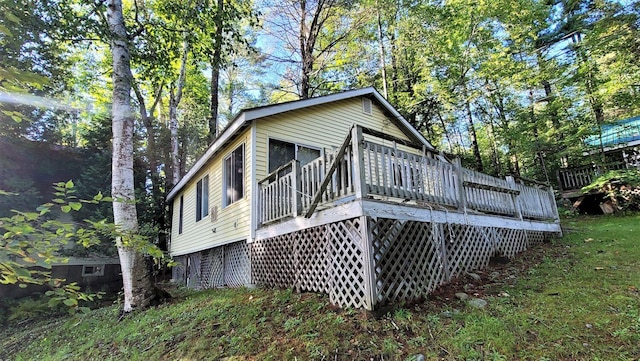 view of home's exterior with a wooden deck