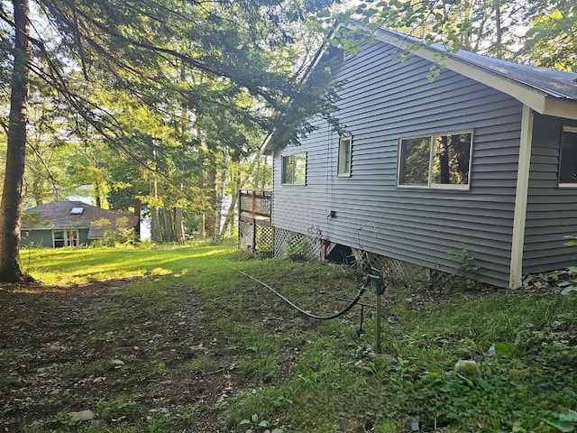 view of home's exterior with a wooden deck