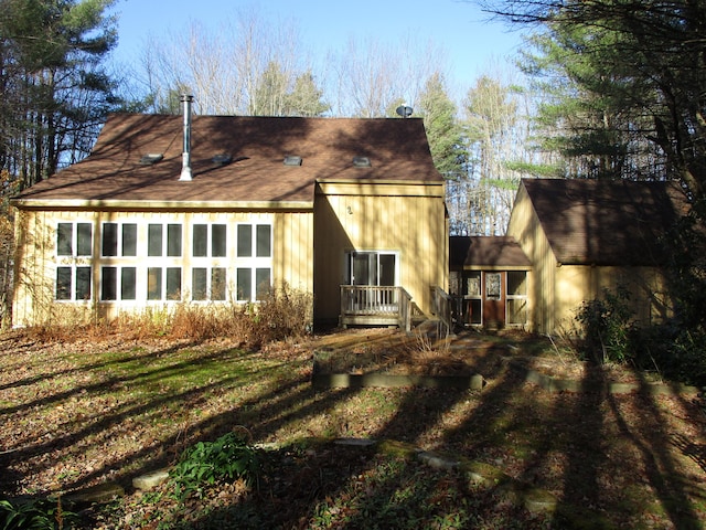 rear view of property with a yard