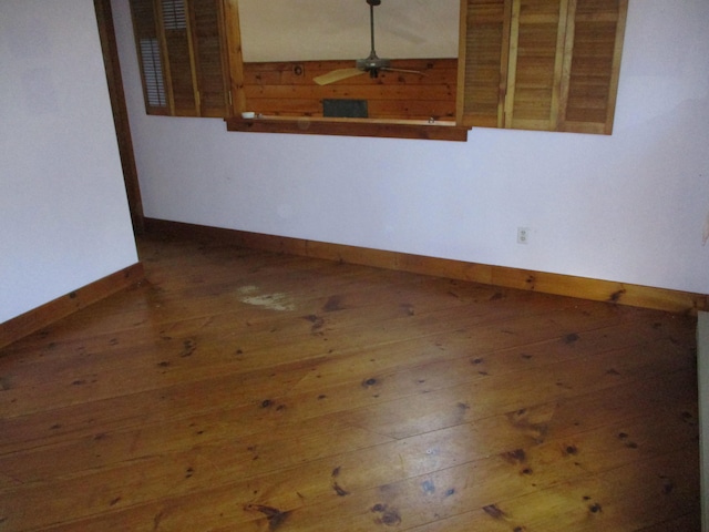 spare room with ceiling fan and dark hardwood / wood-style flooring