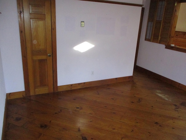 empty room with dark hardwood / wood-style floors