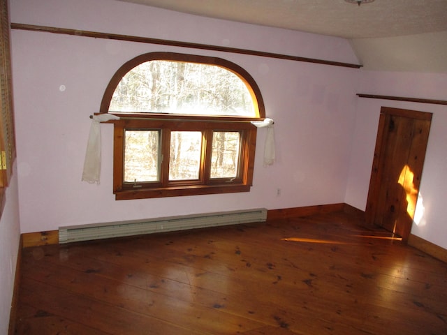 spare room featuring a textured ceiling, a baseboard radiator, vaulted ceiling, and dark hardwood / wood-style floors