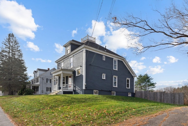 view of side of home with a yard