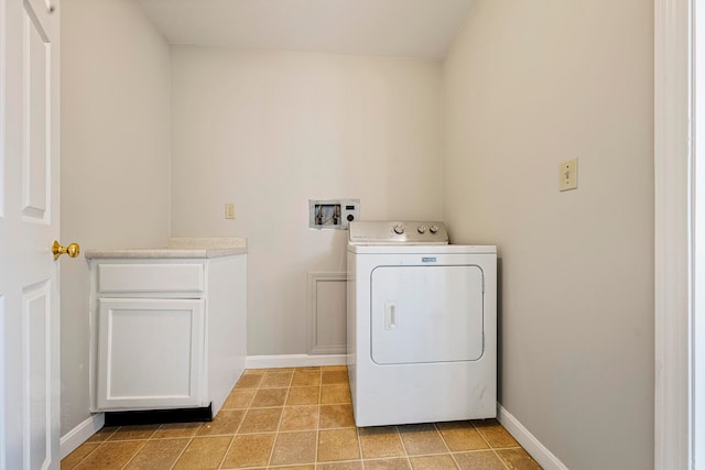 laundry area with cabinets and washer / dryer