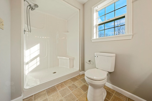 bathroom featuring a shower and toilet