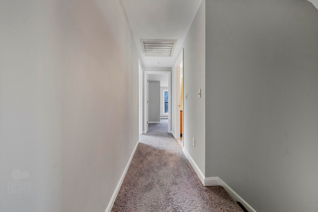 hallway featuring light colored carpet