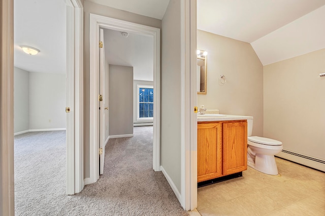 bathroom featuring vanity, a baseboard heating unit, toilet, and vaulted ceiling