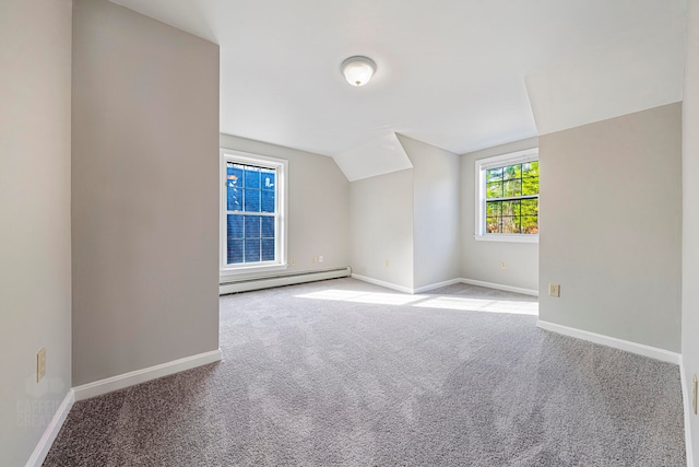 bonus room with light carpet, lofted ceiling, and a baseboard heating unit