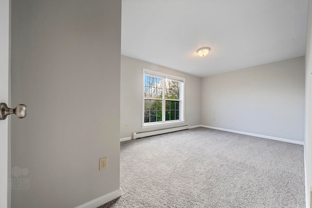 carpeted spare room with a baseboard radiator