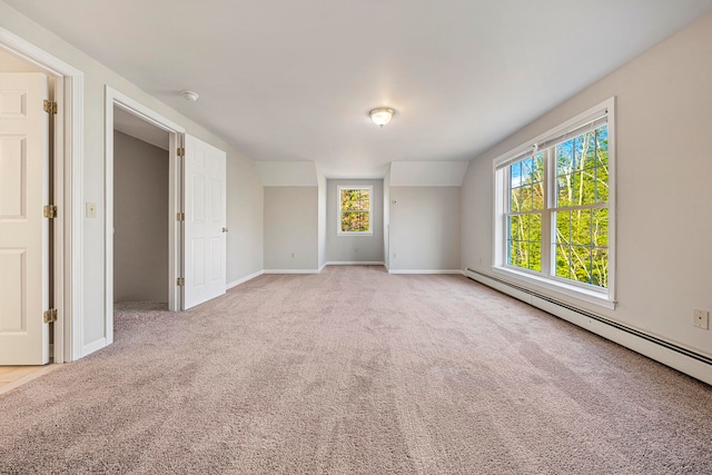 carpeted empty room with a baseboard radiator