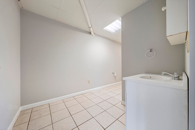 washroom with light tile patterned floors and sink