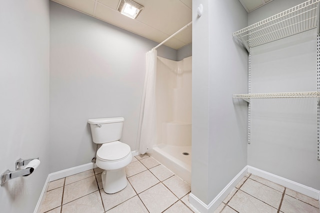 bathroom with tile patterned floors and curtained shower