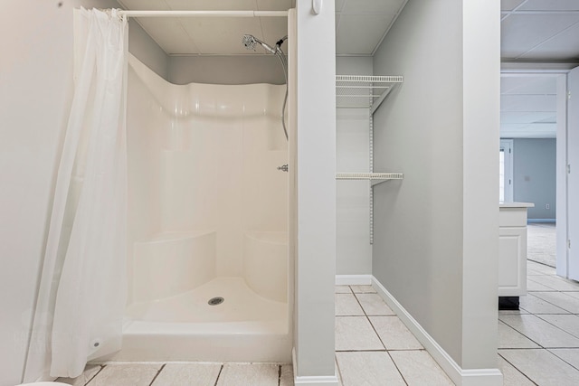 bathroom with a shower with curtain and tile patterned floors