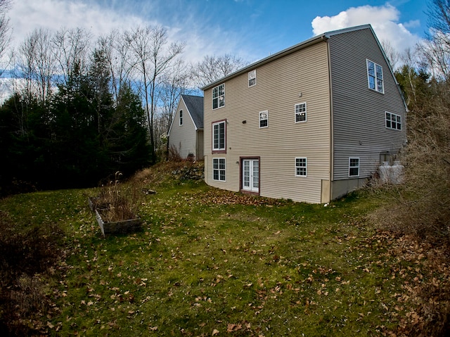 rear view of property with a yard