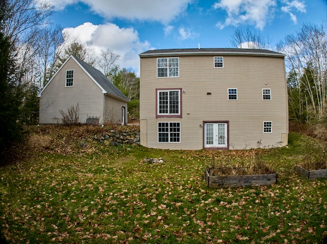 back of house with a lawn