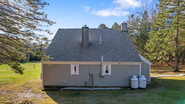 back of property featuring a lawn