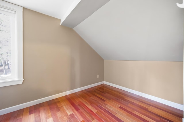 additional living space featuring hardwood / wood-style flooring and lofted ceiling