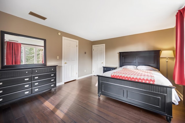 bedroom with dark hardwood / wood-style flooring