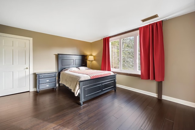 bedroom with dark wood-type flooring