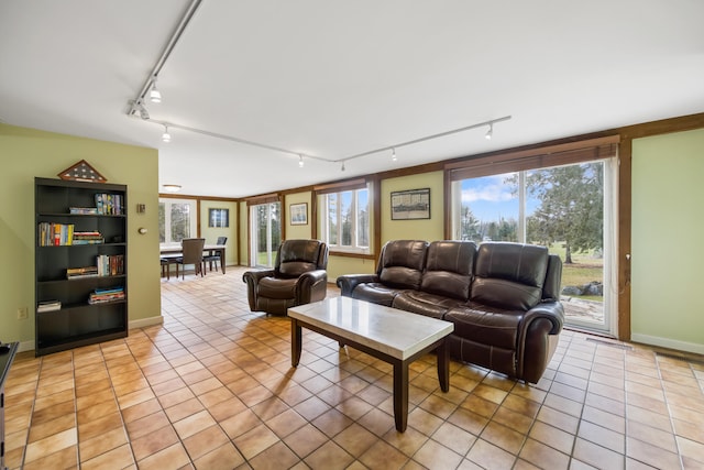 living room featuring light tile patterned floors and rail lighting