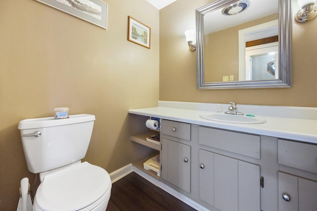 bathroom with hardwood / wood-style floors, vanity, and toilet