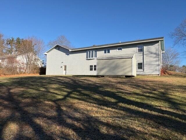 rear view of house with a lawn