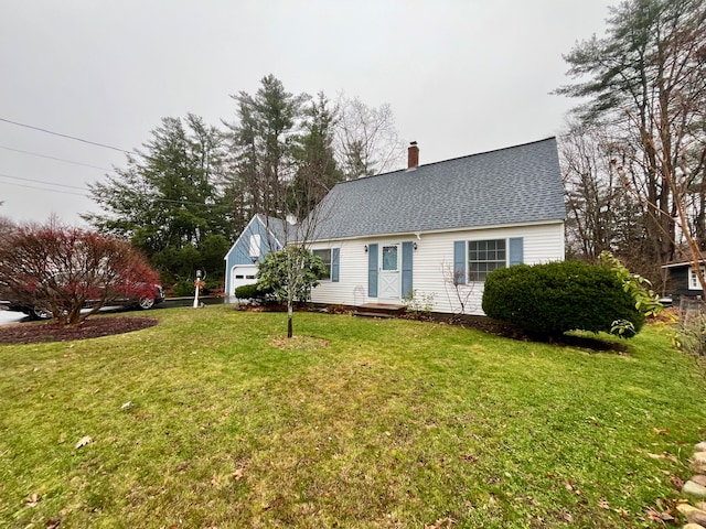 view of front of house with a front yard and a garage